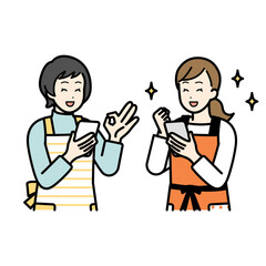 Women having a conversation while holding a cell phone.
