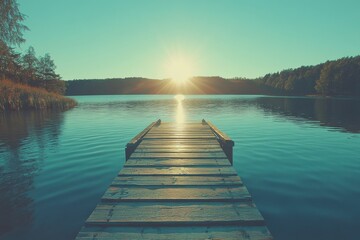 Fototapeta premium Sundown view from a wooden dock over a tranquil lake surrounded by trees