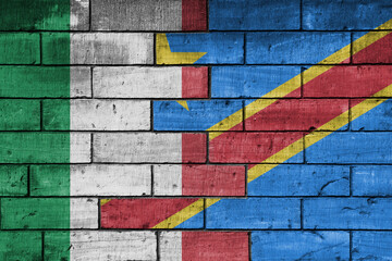 colourful painted big flag of italy and flag of democratic republic of the congo on a massive old...