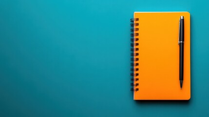 A simple, top-down image of an orange notebook with a pen placed diagonally across it