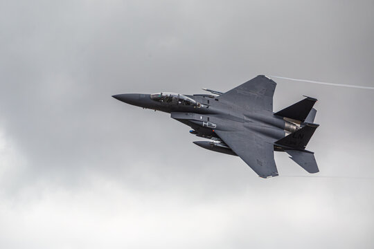 F15 fighter jet taking off from RAF Lakenheath with a cloudy background with landing gear up