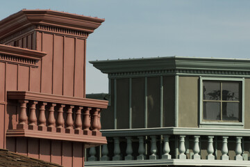 Obraz premium Exterior details of red-brown and green buildings with white balconies in Old Town, Scottsdale
