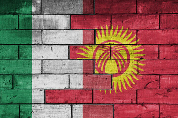 colourful painted big flag of italy and flag of kyrgyzstan on a massive old brick wall background....