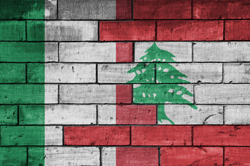 colourful painted big flag of italy and flag of lebanon on a massive old brick wall background....
