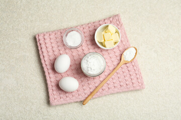 Baking powder and other ingredients for making dough on table, top view