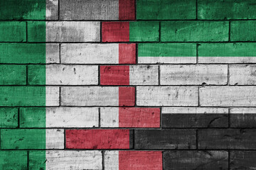 colourful painted big flag of italy and flag of united arab emirates on a massive old brick wall background. concept