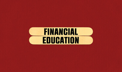 Financial Education Symbol. Concept word Financial Education on beautiful wooden stick. Beautiful Red Chart Paper Background. Business and Financial Education concept. Copy space