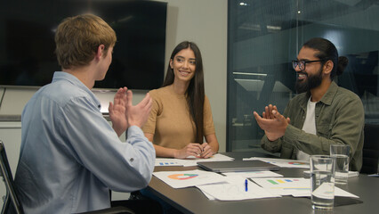 Team leader businesswoman CEO talk to colleagues coworkers discuss corporate business training group coaching in office happy diverse businessmen clients applauding successful presentation applause