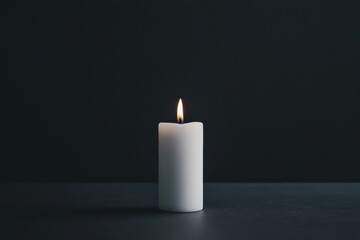 Solitary candle burning in the darkness for serenity and reflection