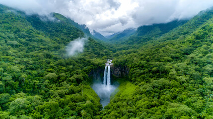 Fototapeta premium Aerial view of lush rainforest waterfall