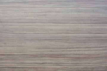 wooden surface with a horizontal grain pattern. The wood appears to have a light, natural finish...
