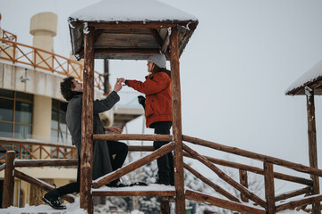 A memorable marriage proposal in a picturesque snowy setting, featuring a modern couple, heartfelt...
