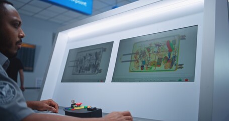 Airport Security Checkpoint: African American Security Officer Controls X-ray Luggage Screening on...