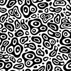 Seamless pattern consisting of black random holey spots of irregular shapes of different sizes drawn by hand with a marker with the effect of an old typography