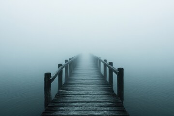Naklejka premium A solitary bridge shrouded in thick fog, its distant end disappearing into the misty unknown