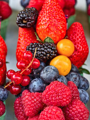 Macro photo of a delicious natural dessert and ingredients for a fruit salad. Raspberries, blueberries, blackberries, currants, strawberries.