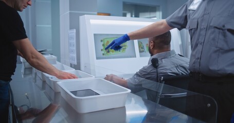 Airport Security Checkpoint during Boarding Flight. Diverse Passengers Put Personal Belongings in...