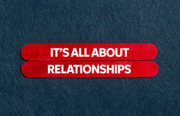 It’s all about relationships message written on red wooden sticks on gray background. Conceptual...