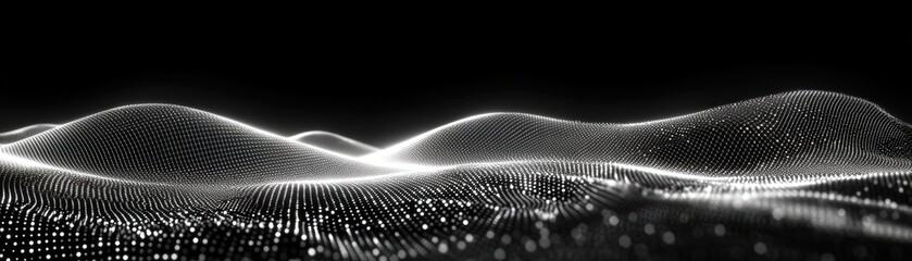 Black and white photograph of a rugged mountain range with dramatic peaks and valleys in the foreground