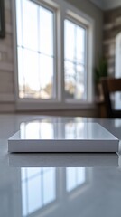 Minimalist white notebook on a reflective table.