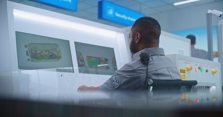 Airport Terminal: African American Security Officer Monitors Baggage Screening Moving on Conveyor...