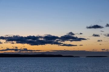 Tranquil Ocean and Island Sunset Scene with Vibrant Evening Colors