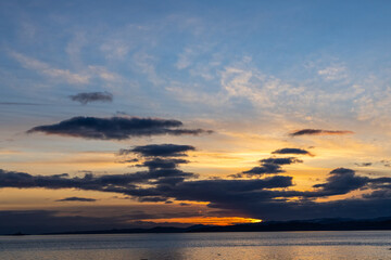 Serene Sunset Over Vancouver Island Coastline with Vibrant Colors and Dramatic Clouds