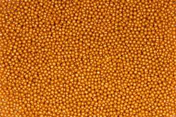 Vibrant Yellow Sugar Sprinkles Background: Macro Photography of Decorative Candy Pearls Used for Cake Decoration and Confectionery Garnish