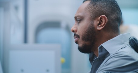 Airport Security Checkpoint: Close Up African American Security Officer Monitors Passenger...