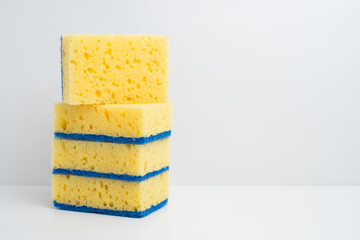 Colored sponges for washing dishes. Kitchen sponge on a light background.
