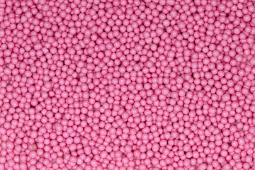 Vibrant Pink Sugar Sprinkles Background: Macro Photography of Decorative Candy Pearls Used for Cake Decoration and Confectionery Garnish
