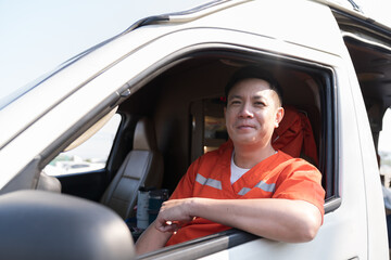 Naklejka premium Asian male ambulance staff member in ambulance car. Wearing ambulance uniform of paramedics talking by portable radio during sitting with paramedics giving injured person first aid