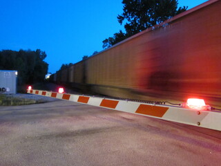 Railroad Crossing Gate fast freight blurred speed dusk