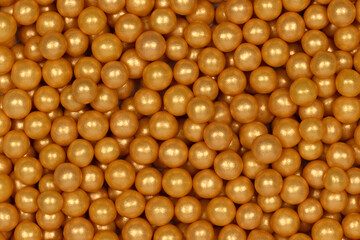 Vibrant Yellow Sugar Sprinkles Background: Macro Photography of Decorative Candy Pearls Used for Cake Decoration and Confectionery Garnish