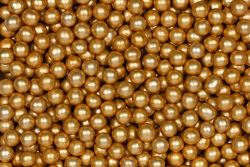 Vibrant Yellow Sugar Sprinkles Background: Macro Photography of Decorative Candy Pearls Used for Cake Decoration and Confectionery Garnish