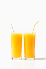 there are two glasses of orange juice with straws on the side