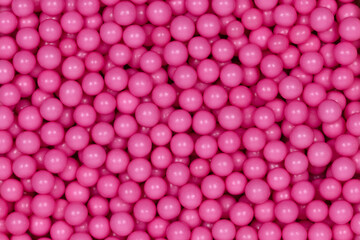 Vibrant Pink Sugar Sprinkles Background: Macro Photography of Decorative Candy Pearls Used for Cake Decoration and Confectionery Garnish