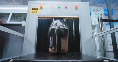 Airport Security Checkpoint: Passenger Takes Suitcase from Conveyor Belt after Luggage Screening...