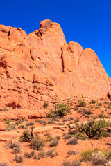 Fototapeta premium A rocky mountain with a tree in the foreground
