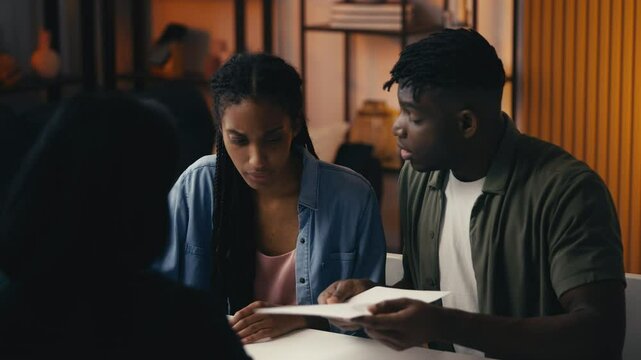 Couple presents their rejected insurance claim to an agent, feeling frustrated