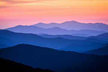 Stunning mountain range silhouetted against a vibrant sunset sky creating a breathtaking view