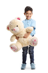 Full length portrait of a boy holding a teddy bear and smiling