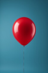 there is a red balloon that is attached to a string