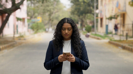 Serious Indian Businesswoman Texting 