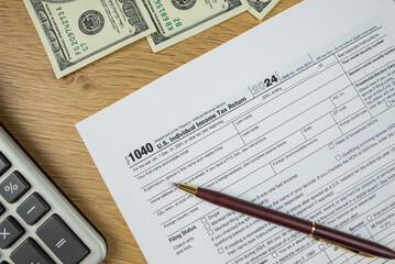 Obraz premium us tax forms 1040. 2024 year, business tax time concept.