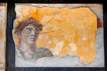 fresco of the deity of the God Apollo or Sol with the cosmic crown and a whip, in the Tavern of the Four Deities in Pompeii, Naples, Campania, Italy, buried by Vesuvius