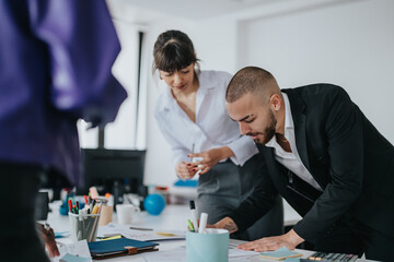 A team of business professionals engaged in a brainstorming meeting, reviewing documents and collaborating on project ideas at a contemporary office workspace, fostering teamwork and productivity.