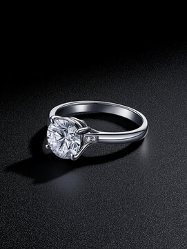 Solitaire Elegance: A classic solitaire diamond engagement ring, sparkling with brilliance on a dark surface. The clean lines and elegant design highlight the stunning centerpiece diamond. 