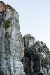 Large rocky rocks. Rocks of rocks. Gray moss-covered rocks