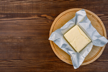 Butter that adds flavor to meals and is for breakfast on a wooden background